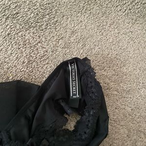 Sexy size XS black VS panty with flirty bow in back. Give your partner a present